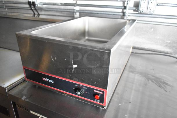 Winco commercial food warmer with adjustable temperature control, stainless steel body, and heating indicator, shown in new condition.