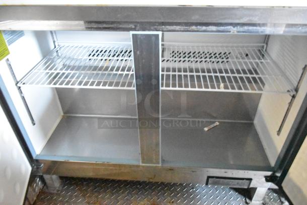 Food trailer interior showing a commercial-grade shelving unit with metal racks. Ideal for storage and cooling setup.