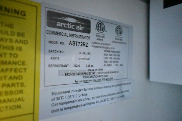 Label showing Arctic Air commercial refrigerator model AST72RZ details, including refrigerant type and serial number.