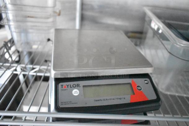 Taylor digital kitchen scale, model TE22FT, shown on a wire shelf. Capacity: 22 lb. Appears in excellent condition.