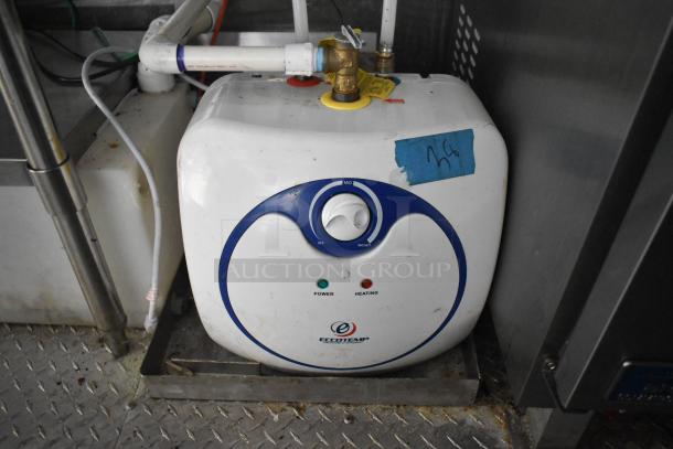 Eccotemp water heater in food trailer, featuring power and heating indicators, installed with plumbing connections.