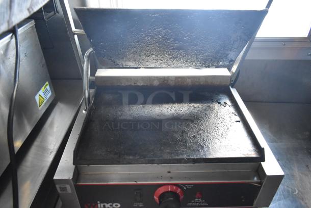 Commercial-grade grill in food trailer, featuring Winco branding. Ideal for mobile kitchen setup. Near-new condition.