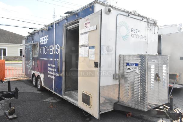 Brand new food trailer with commercial equipment, Pyrochem hood, Arctic Air coolers, and more. Reef Kitchens branding visible.