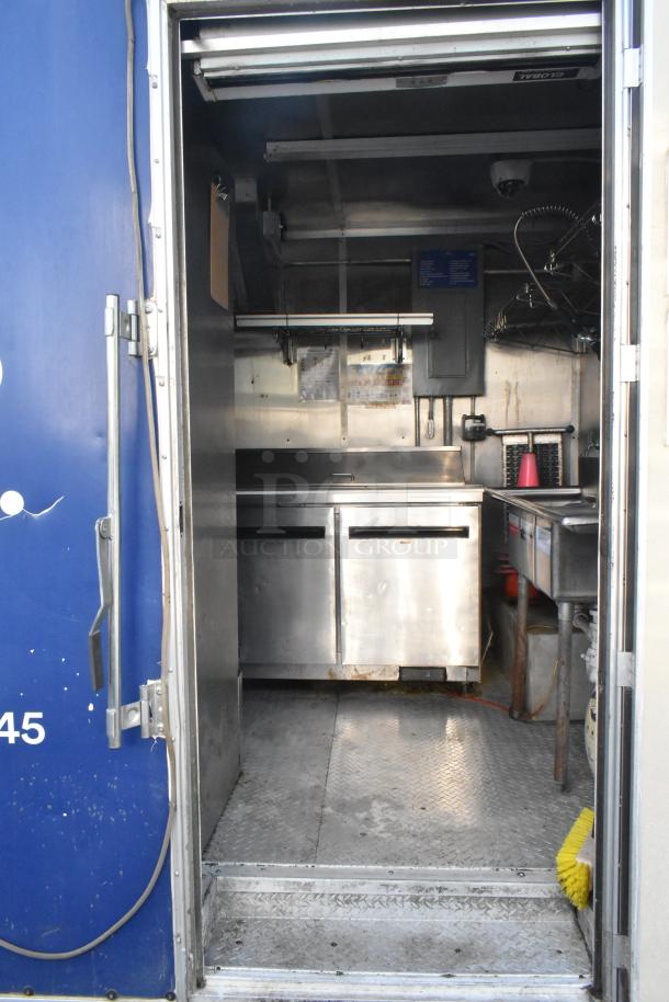 New commercial food trailer with Arctic Air prep tables, Pyrochem hood, and Pitco fryer. Ready for ghost kitchen use.