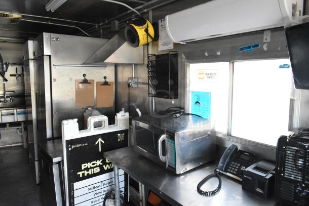 Fully equipped food trailer with commercial-grade equipment, including Pyrochem hood, Arctic Air coolers, Wells range, and Pitco fryer.