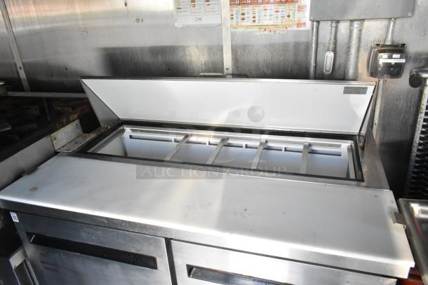 Stainless steel Arctic Air prep table with open top, showing multiple food compartments, in new condition.
