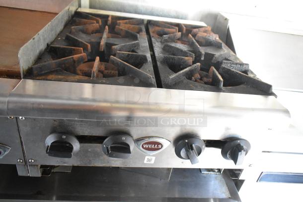 Wells range with dual burners and control knobs, part of a fully equipped food trailer.
