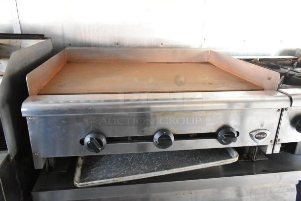 Wells flat top grill in food trailer, featuring temperature controls and durable stainless steel construction, ideal for mobile kitchen use.