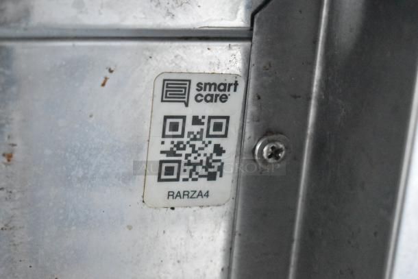 QR code label on a metal surface, labeled "smart care" with text "RARZA4" beneath.
