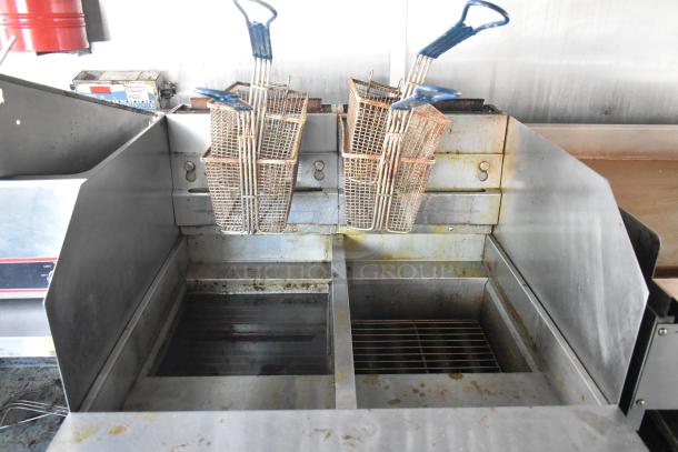 Commercial-grade Pitco Frialator gas fryer in mobile kitchen, featuring stainless steel fry baskets and grease hood.