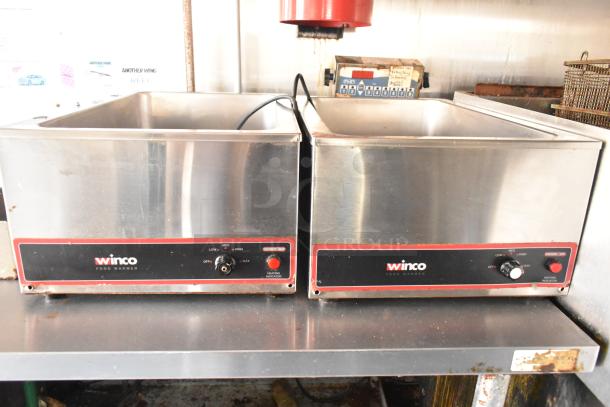 Winco food warmers in stainless steel, featuring adjustable heat controls, used in a fully outfitted mobile kitchen.