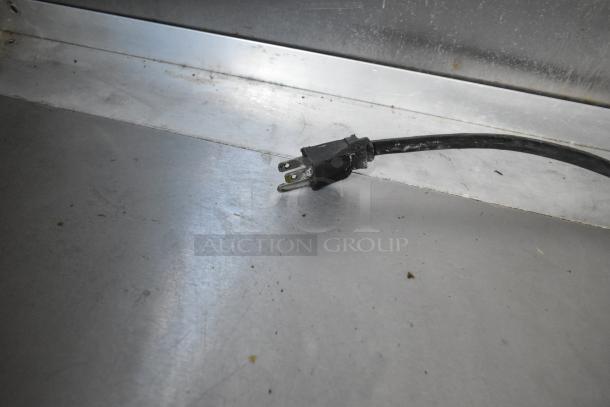 Power cord on metal surface in a fully outfitted food trailer, equipped with commercial-grade appliances for various culinary concepts.