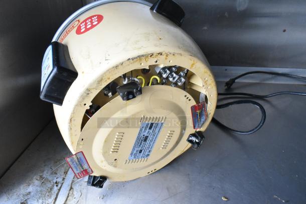 Electric rice cooker showing interior components, Wow Bao branding visible. Slight wear, tagged with safety instructions.