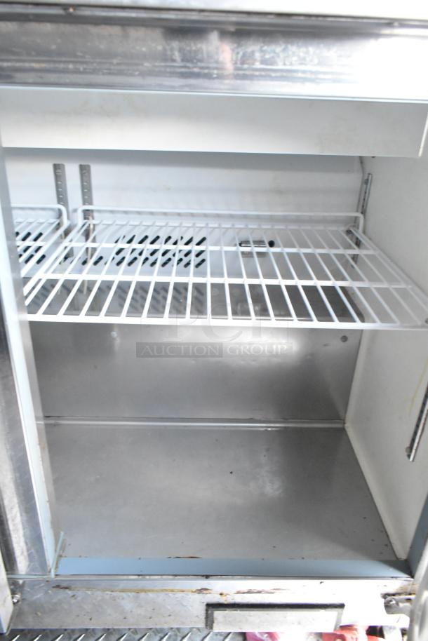 Empty commercial-grade Arctic Air cooler interior with wire shelf, visible metal surfaces, and clean condition.