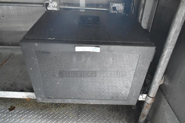 Black electrical box with diamond plate door in a mobile kitchen. Includes label "Great Lakes" above panel.