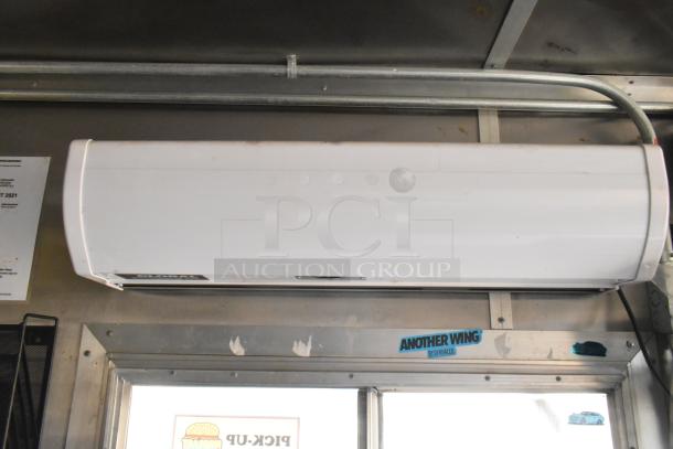 Fully outfitted food trailer interior showing air conditioning unit, metal walls, and "ANOTHER WING BY DJ KHALED" sticker.