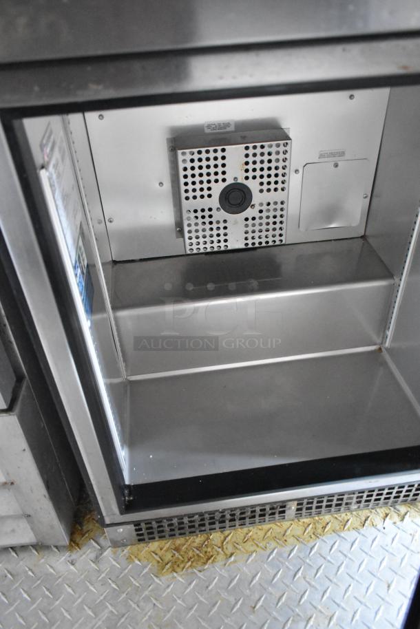 Interior of commercial food trailer showing stainless steel Arctic Air cooler with ventilation panel and clean surface.