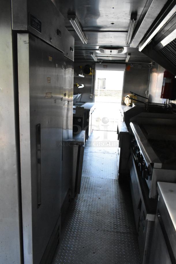 Newly outfitted food trailer with commercial equipment, including Pyrochem hood, Arctic Air coolers, Wells range, and Pitco fryer.