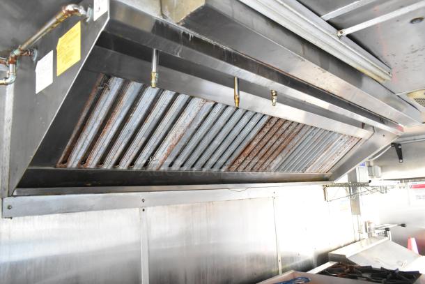 Interior of a fully equipped food trailer featuring a Pyrochem grease hood system. Stainless steel surfaces, in pristine condition.