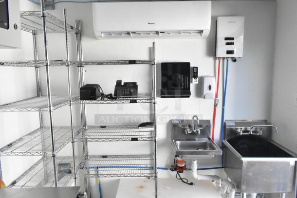 Brand new unbranded food trailer with commercial-grade equipment including Gree air unit, Camplux water heater, shelving, sinks, and faucets.