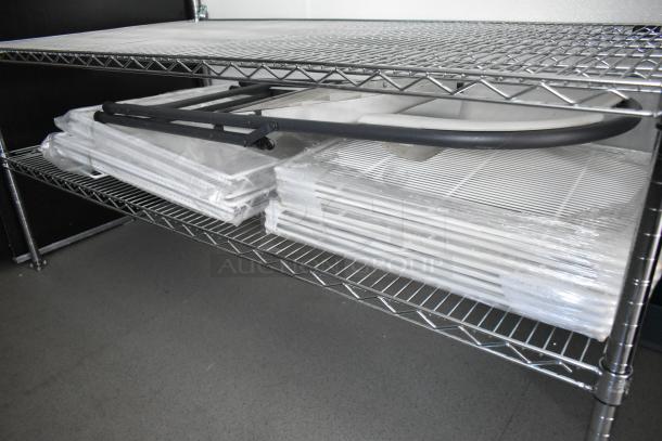 Wire shelving unit inside food trailer, holding equipment and supplies. Suitable for a mobile kitchen setup.