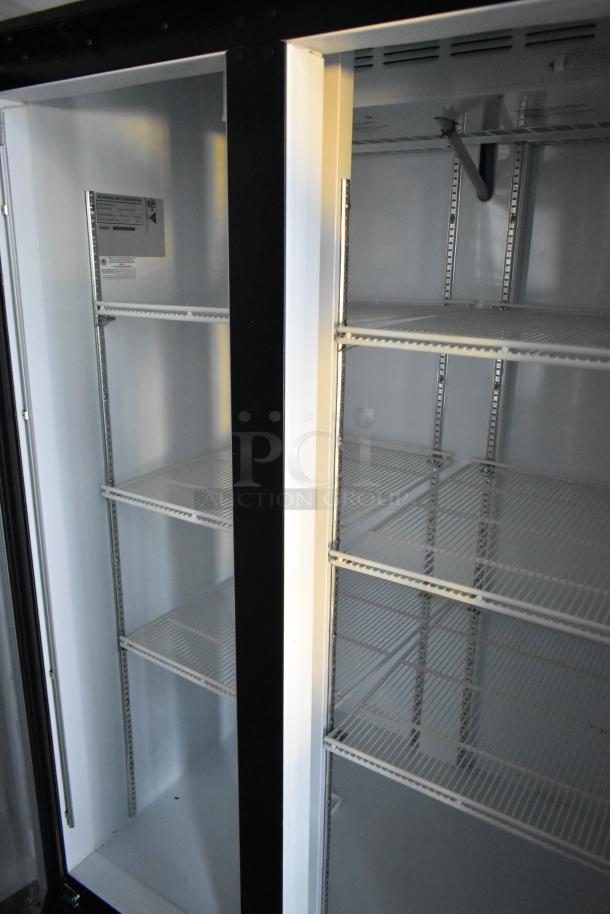 Interior view of a brand new mobile kitchen trailer featuring empty wire shelving units, ready for commercial use.