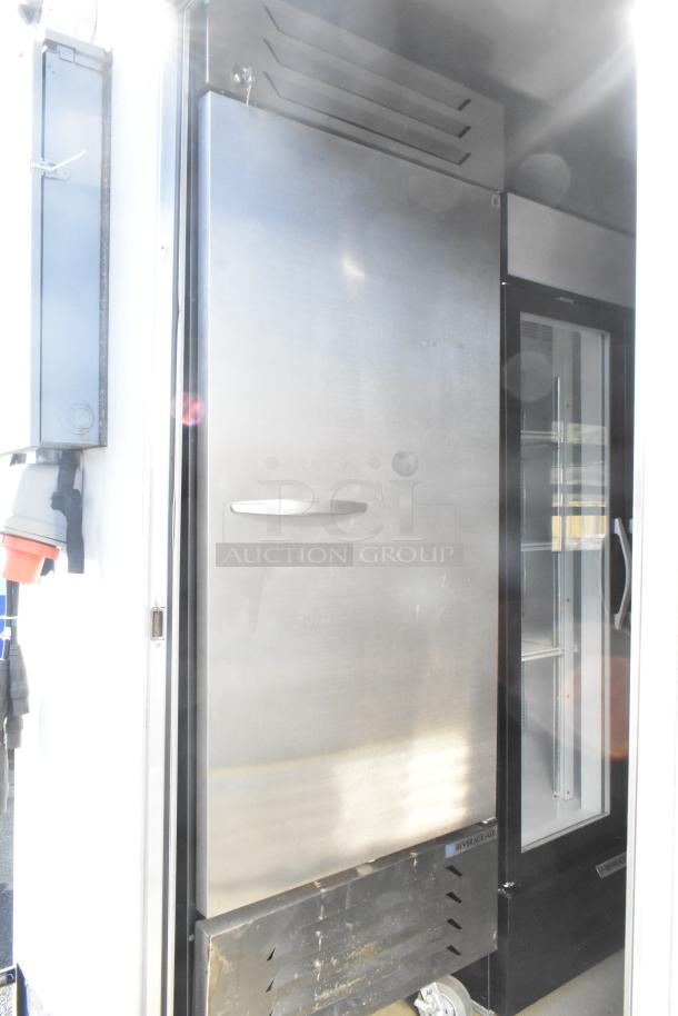 Fully equipped food trailer with Beverage Air reach-in cooler and freezer, featuring commercial-grade fixtures and security system.