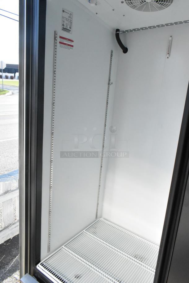 Interior of a new Beverage Air reach-in cooler, featuring white wire shelving, adjustable rails, and visible wiring.