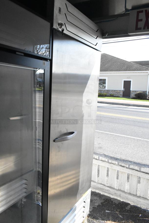 Stainless steel food trailer interior with commercial-grade Beverage Air cooler and freezer, equipped for various concepts.