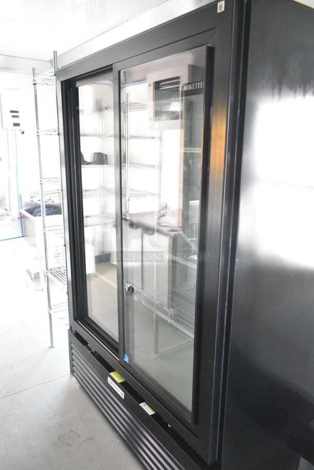 Brand new unbranded food trailer interior with Beverage Air cooler, wire shelving, and commercial kitchen setup.