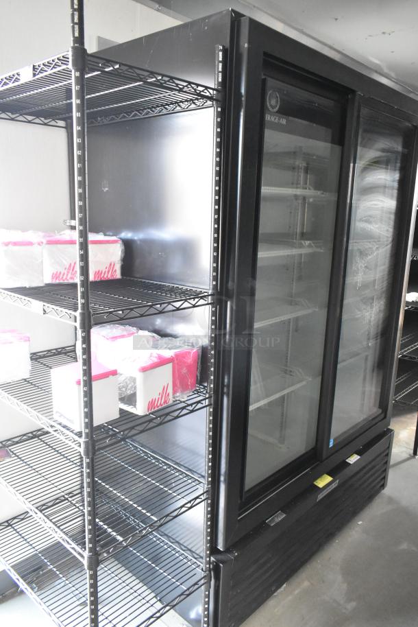 Mobile food trailer interior with commercial-grade equipment, including Beverage Air coolers and freezers, wire shelving, and labeled boxes.