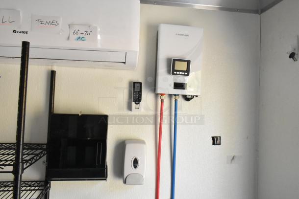 Interior of a fully equipped unbranded food trailer featuring a Gree air conditioner and Camplux water heater.