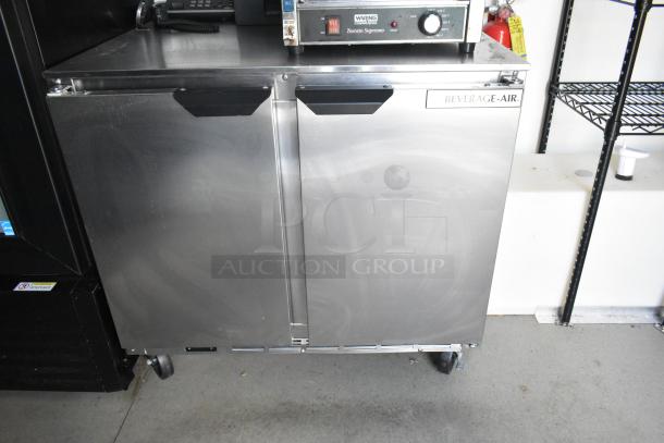 Beverage Air commercial-grade cooler, stainless steel, dual doors, on wheels. Suitable for food trailer setup.