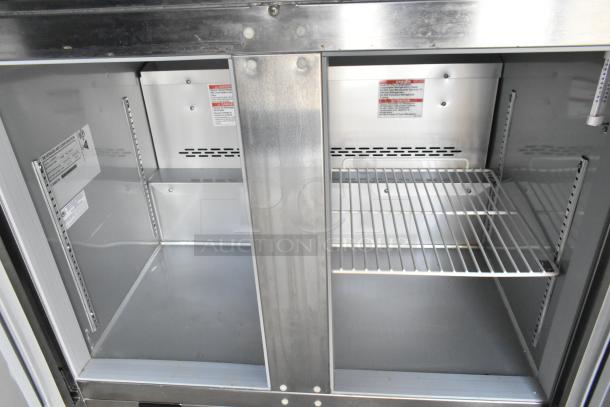 Commercial-grade Beverage Air reach-in cooler interior, brand new, with metal shelves and safety instruction labels visible.