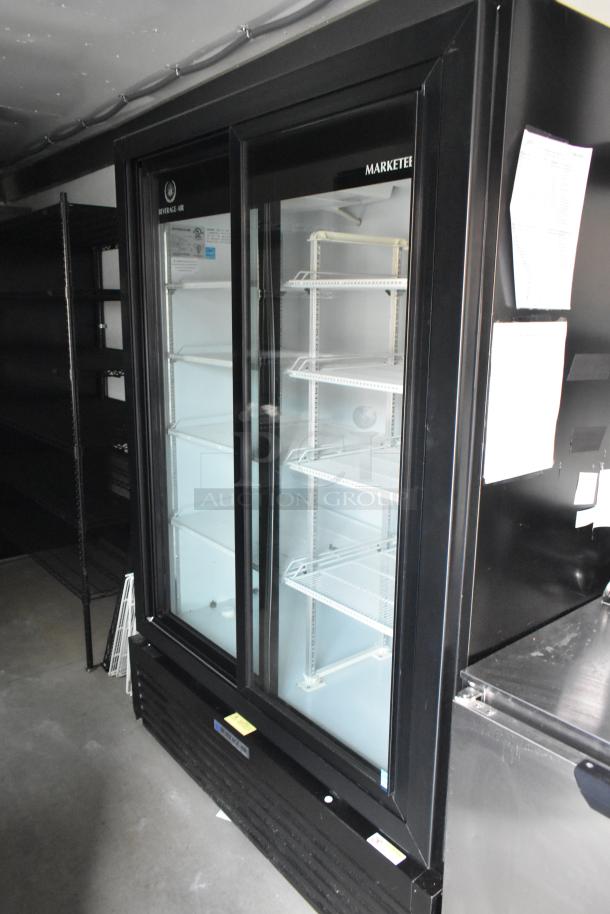 Beverage Air Marketeer reach-in cooler with glass doors, shelving, and commercial-grade finish, inside a food trailer.