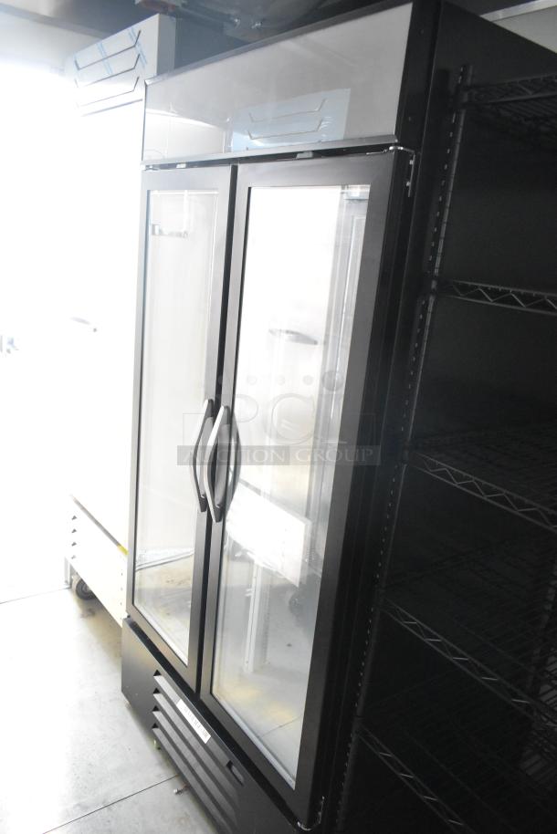 Commercial-grade Beverage Air reach-in cooler in new condition with double glass doors, sleek design, and ample shelving space.