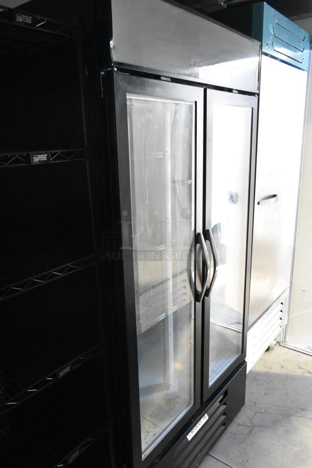 New food trailer interior showing a Beverage Air cooler and freezer, and shelving. Ideal for a mobile kitchen setup.