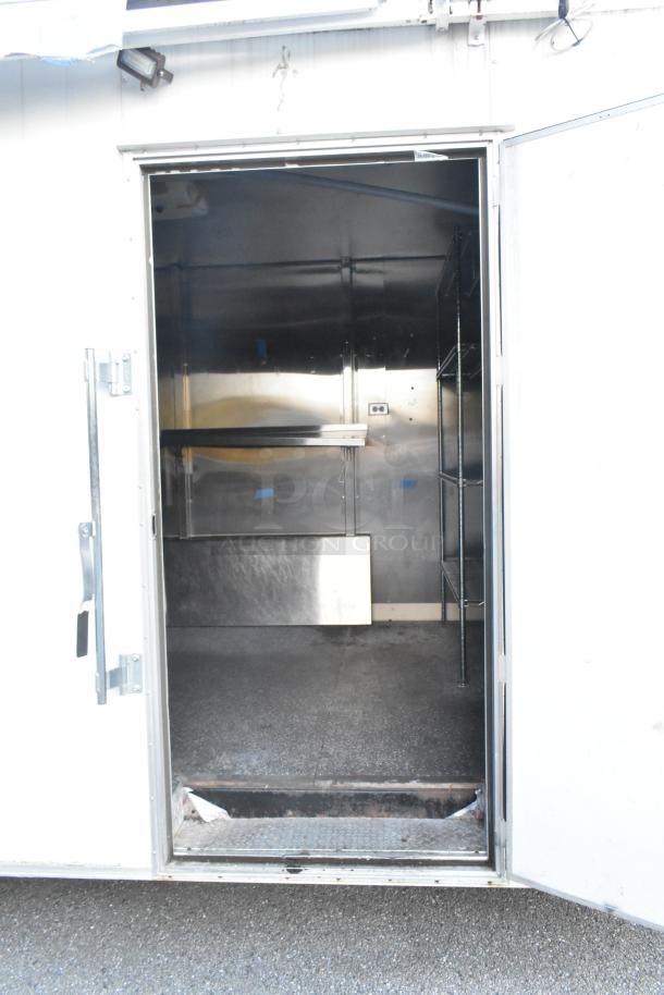New unbranded food trailer with Coleman's Mack Ventilation, shelving, and more. Ready for equipment. Open door view.