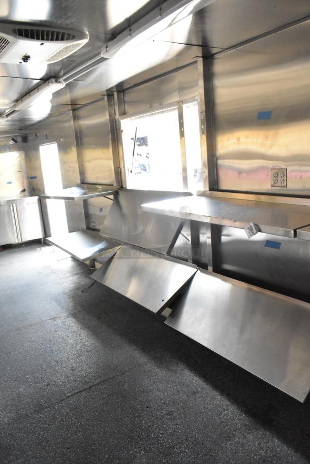 Brand new unbranded food trailer, ready for customization. Features Coleman's Mack Ventilation, shelves, metal counters.