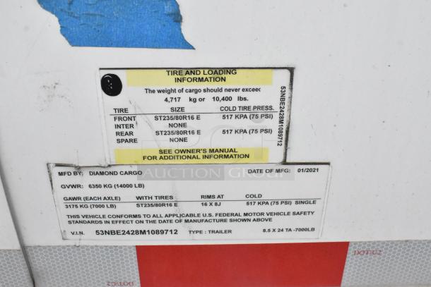 Label on Diamond Cargo trailer showing tire and loading info, manufactured January 2021, GVWR 14,000 lbs.