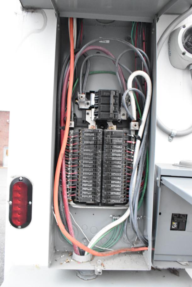 Electrical panel and wiring inside the 2021 Cruising Kitchens 24' mobile food trailer, showing clear organization and connectivity.