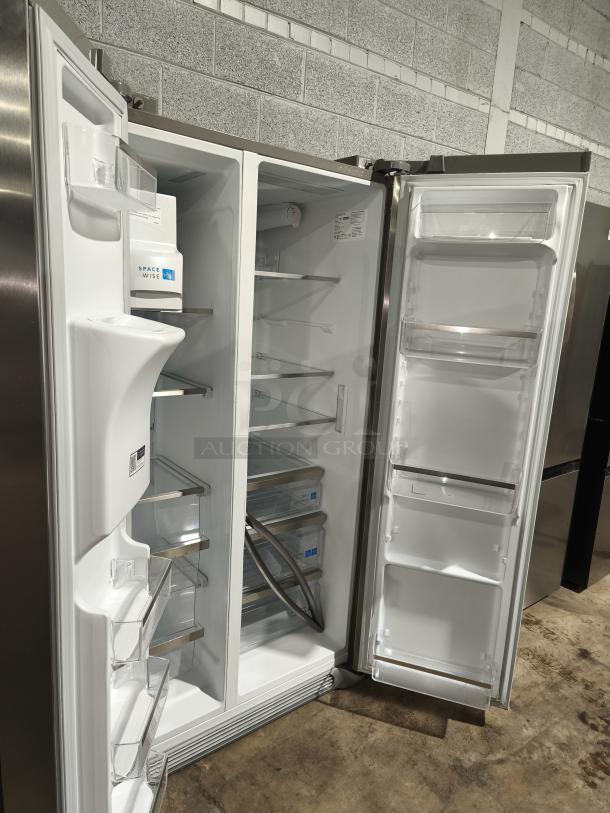 New Frigidaire Gallery side-by-side refrigerator, model GRSS2652AF, 25.6 cu ft, stainless steel finish, open doors showing interior.
