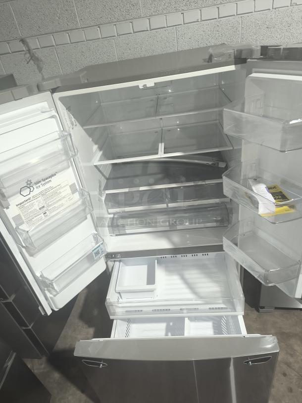 NEW LG LRFS28XBS 27.7 cu ft Smart French Door Refrigerator, open view, spacious interior, ice system label visible.