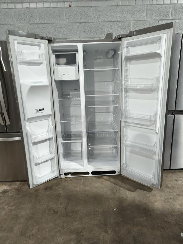 Frigidaire 25.6 cu ft 36" side-by-side refrigerator, model FRSS26L3AFE, like new, stainless steel, open doors display spacious interior.
