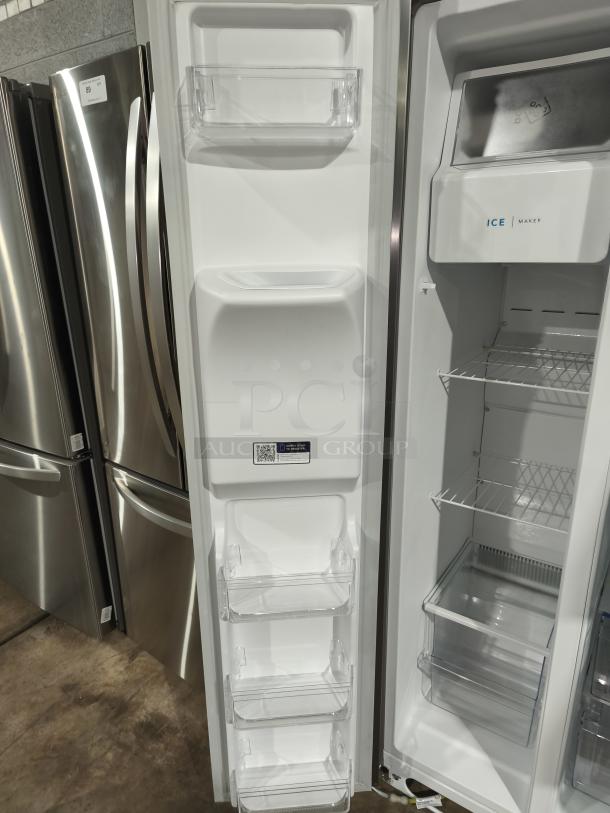Frigidaire 25.6 cu ft side-by-side refrigerator, model FRSS26L3AFE, like new, with ice maker and adjustable shelves.