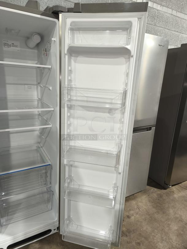 Frigidaire 25.6 cu ft side-by-side refrigerator, model FRSS26L3AFE, like new, open door showing shelves and bins.