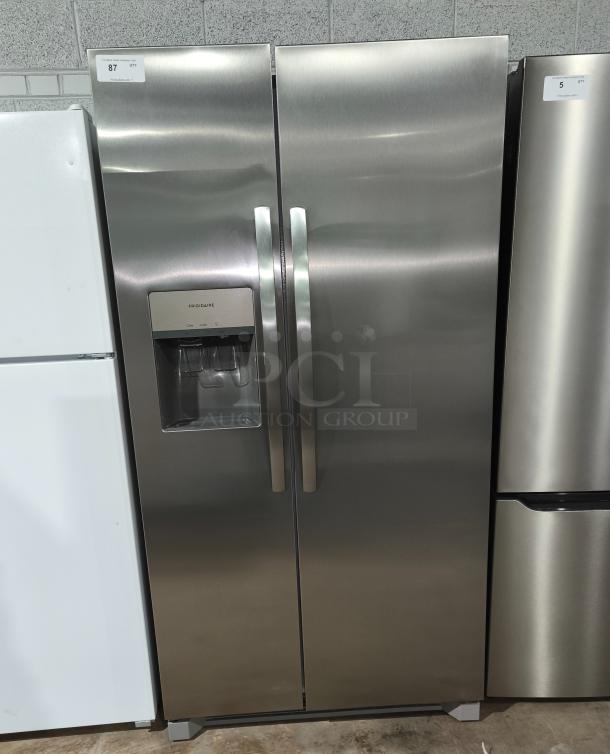Frigidaire 25.6 cu ft side-by-side refrigerator, model FRSS26L3AFE, like new condition, stainless steel finish, water dispenser.