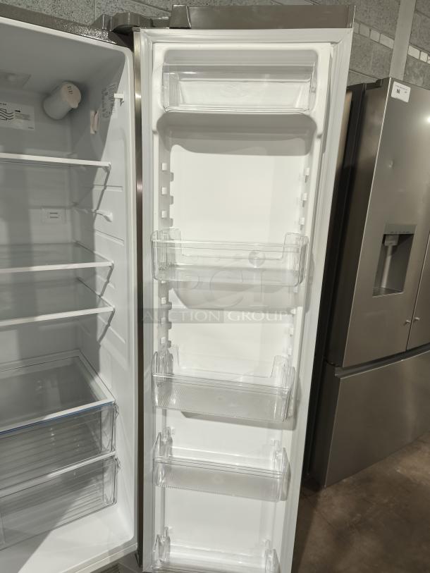 Frigidaire 25.6 cu ft side-by-side refrigerator, model FRSS26L3AFE, like new condition. Spacious interior shelves and clear door bins.