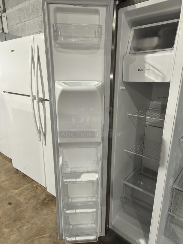 Frigidaire 25.6 cu ft side-by-side refrigerator, model FRSS26L3AFE. Like new, features ice maker, clear shelves.