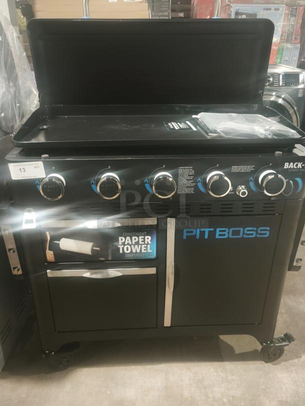 Brand new Pit Boss PB5BGD2 gas griddle with 5 burners, cabinet, paper towel dispenser, and wheels for mobility.